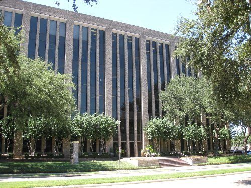 1800 St. James Place behind the live oaks, concrete vertical fin columns