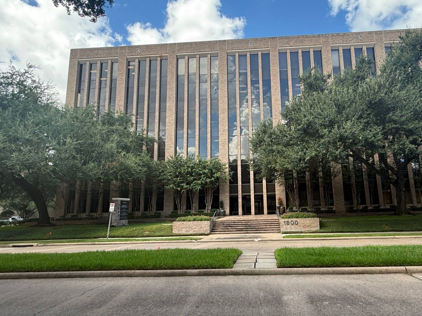 The front of 1800 St. James Place behind the live oaks